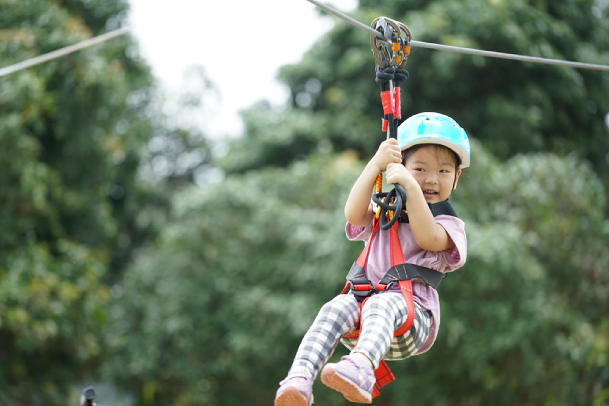 Young child enjoying a special zipline
