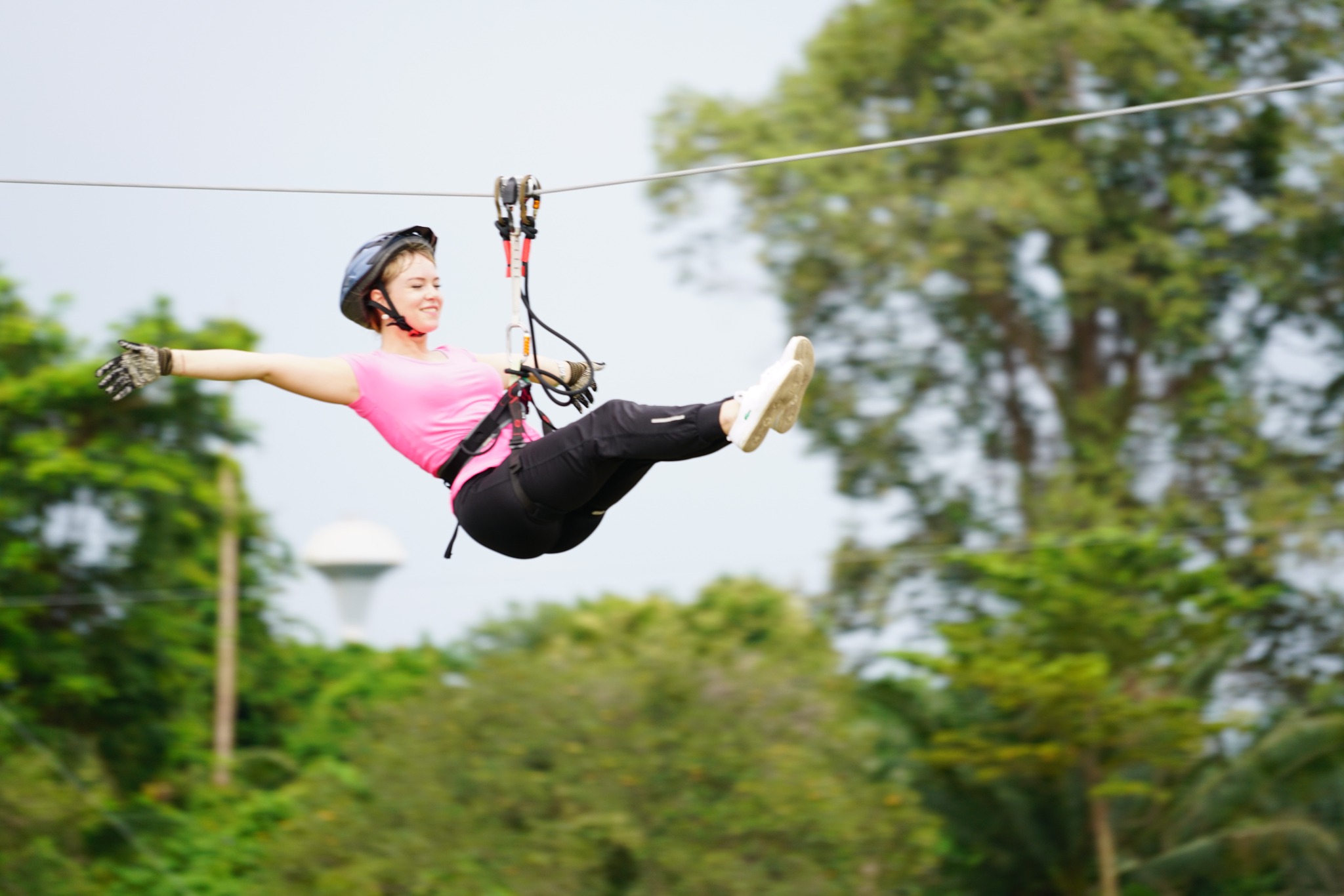 Guest posing while riding the zipline