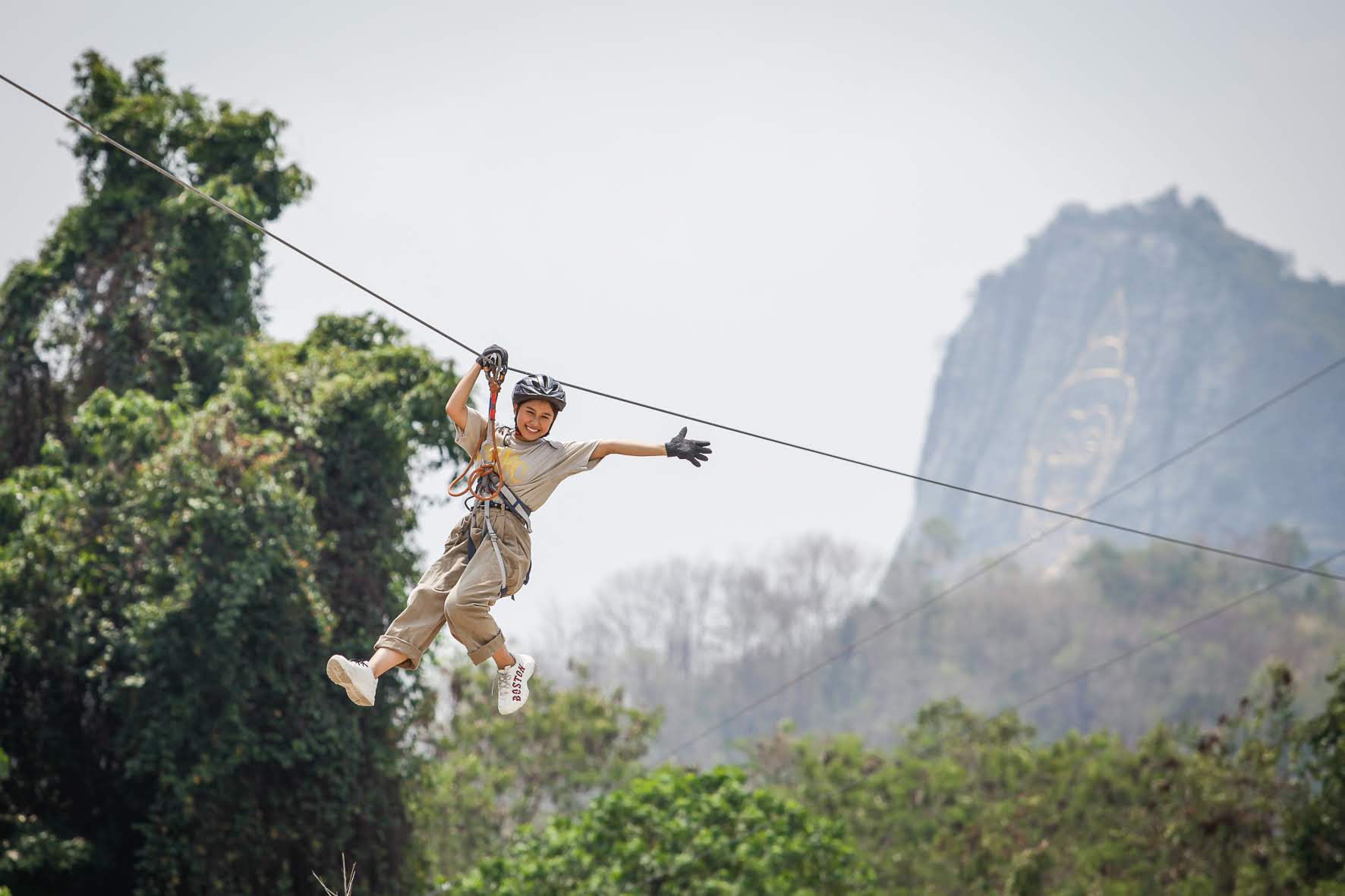 Guest enjoying a Tarzan zipline with a mountain view